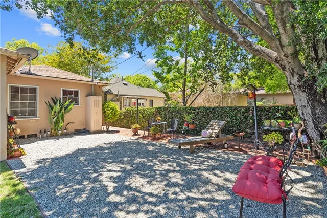a row of palm trees in front of a house