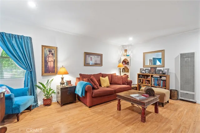 a living room with furniture a rug and a window