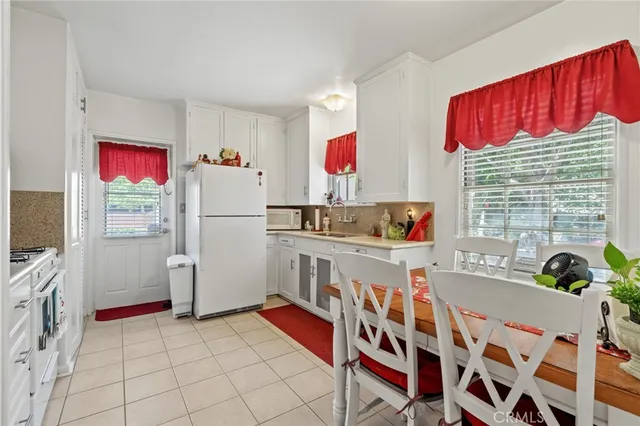 a kitchen with stainless steel appliances a sink and a refrigerator