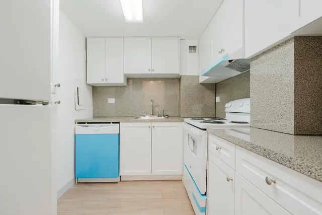 a kitchen with a sink cabinets and appliances