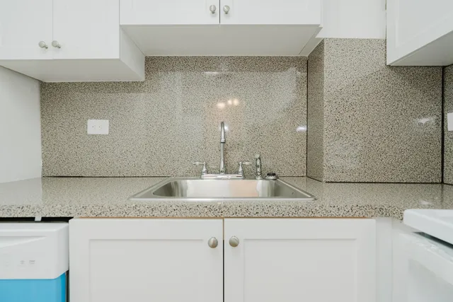 a kitchen with a stove top oven and cabinets