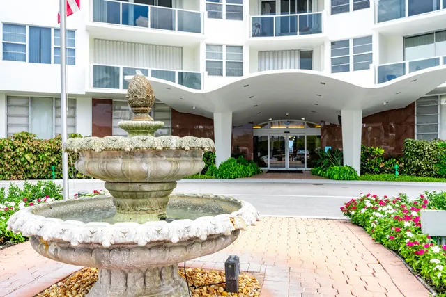 a front view of a building with an outdoor seating