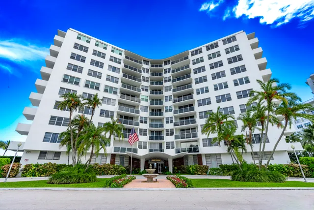 a view of a tall building and a yard