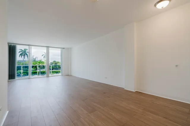 a view of a room with wooden floor and window