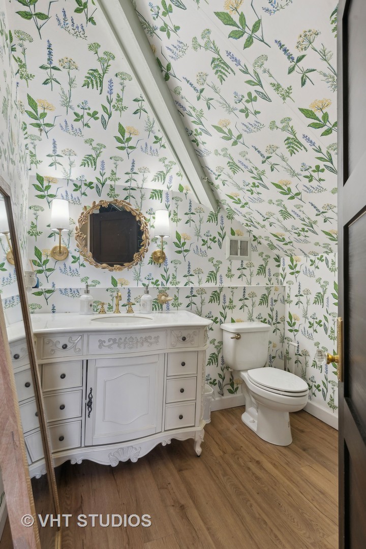 3762 North Harding Avenue Chicago, IL 60618 - Photo 2 of 25 a bathroom with a granite countertop toilet and a sink