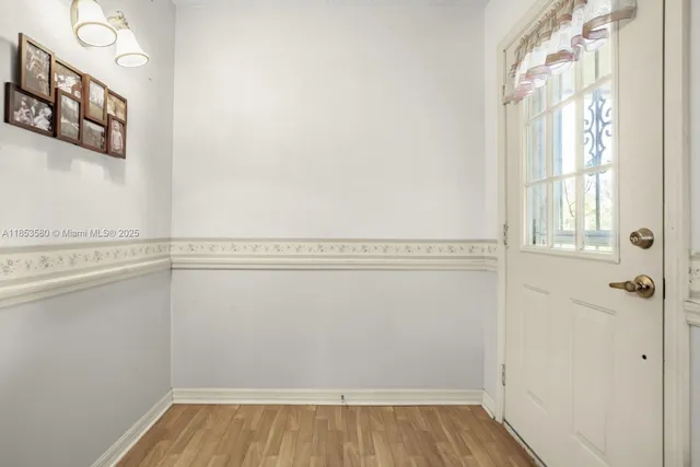 a view of a room with rack on the wall and a window