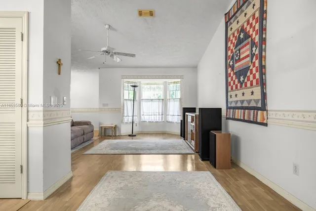 a view of a livingroom with furniture window and wooden floor