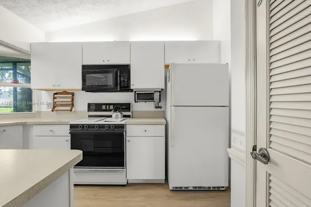 a kitchen with a refrigerator stove and microwave
