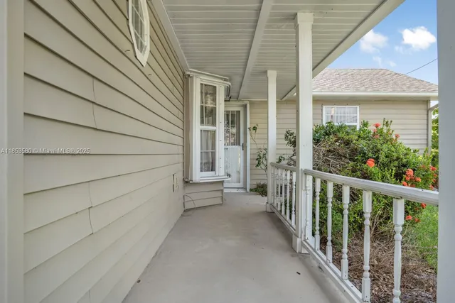 a view of a house with a wooden fence