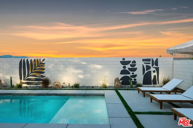 a view of a house with pool and a yard