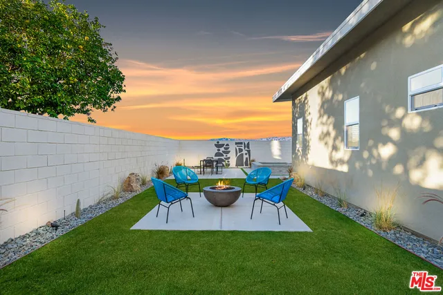 a view of a chair and table in backyard