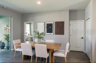 10095 Southwest 44th Terrace Ocala, FL 34476 - Photo 3 of 12 a view of a dining room with furniture and wooden floor