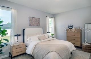 10095 Southwest 44th Terrace Ocala, FL 34476 - Photo 5 of 12 a bedroom with a bed and a closet