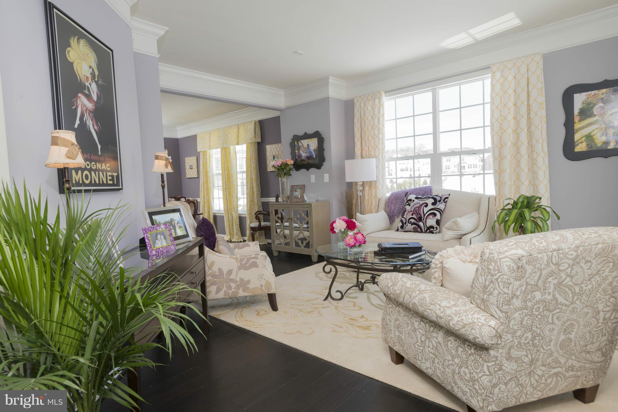 2302 Winterwood Road Baltimore, MD 21209 - Photo 2 of 30 a living room with furniture and a potted plant