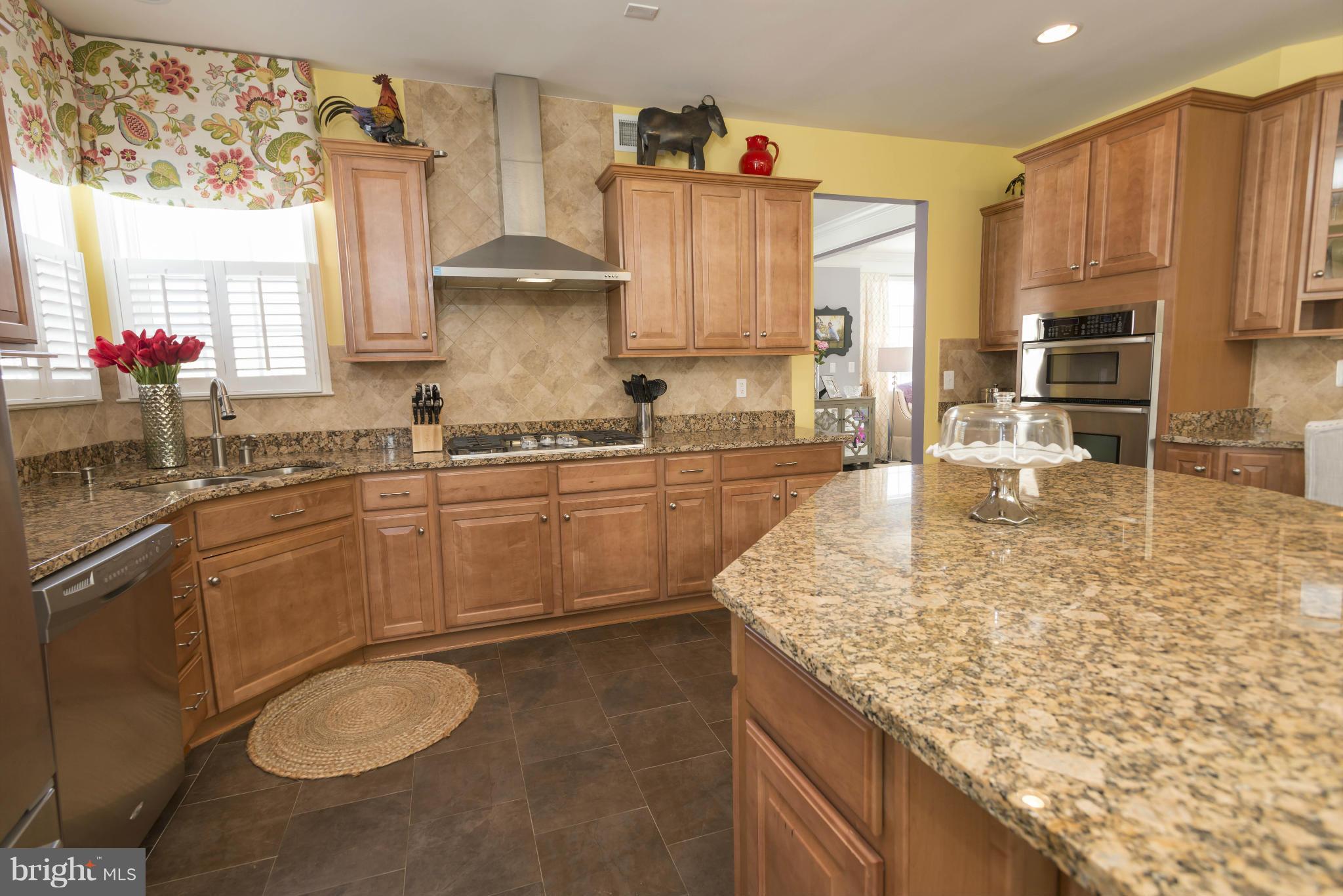 2302 Winterwood Road Baltimore, MD 21209 - Photo 13 of 30 a kitchen with stainless steel appliances granite countertop a sink stove and cabinets
