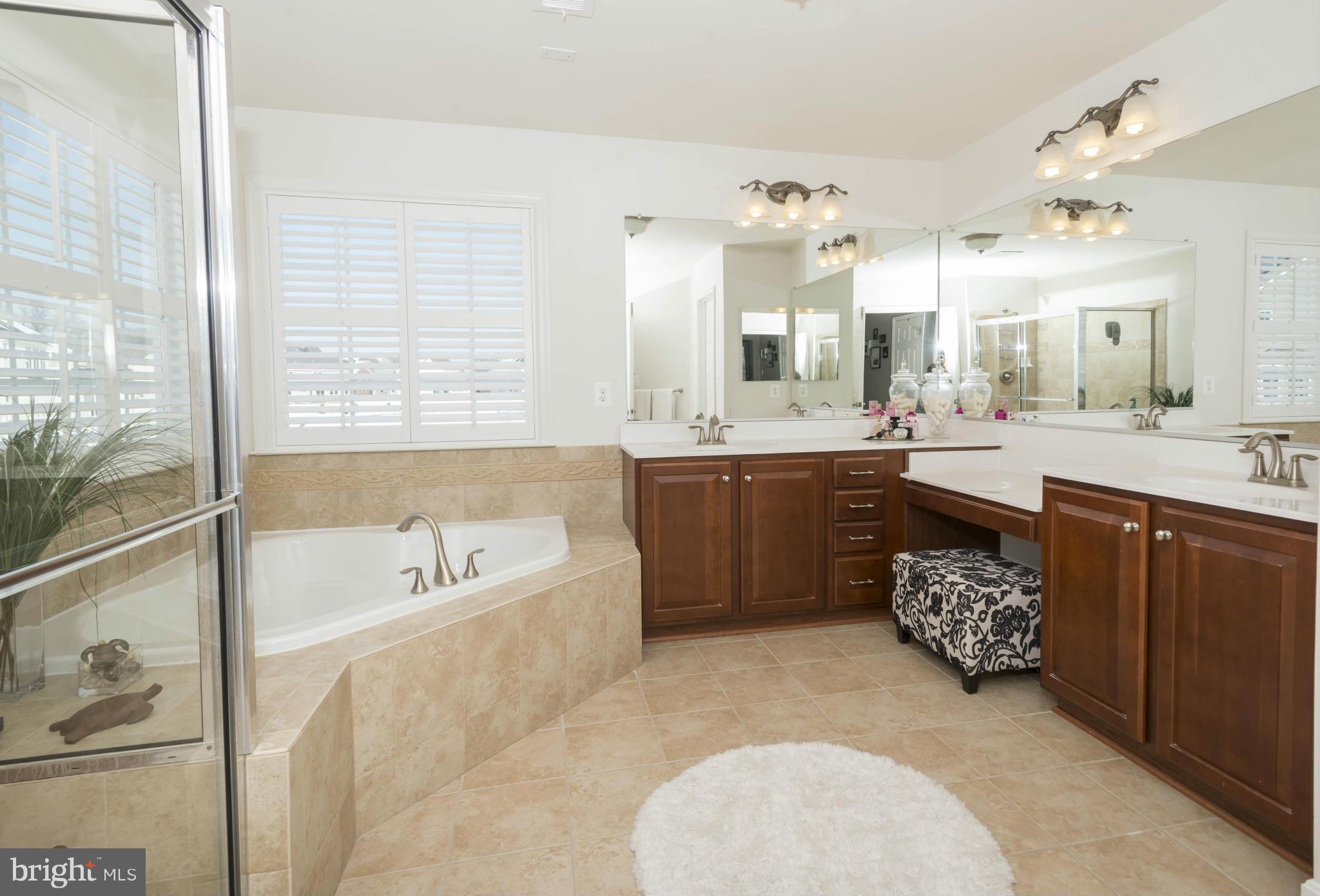 2302 Winterwood Road Baltimore, MD 21209 - Photo 22 of 30 a large bathroom with a large tub sink and mirror