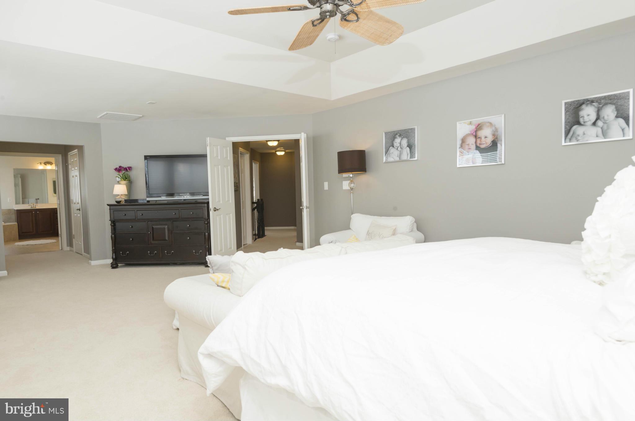 2302 Winterwood Road Baltimore, MD 21209 - Photo 24 of 30 a spacious bedroom with a bed and a chandelier