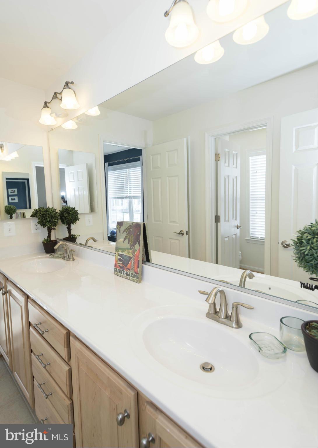 2302 Winterwood Road Baltimore, MD 21209 - Photo 25 of 30 a bathroom with a sink and a mirror