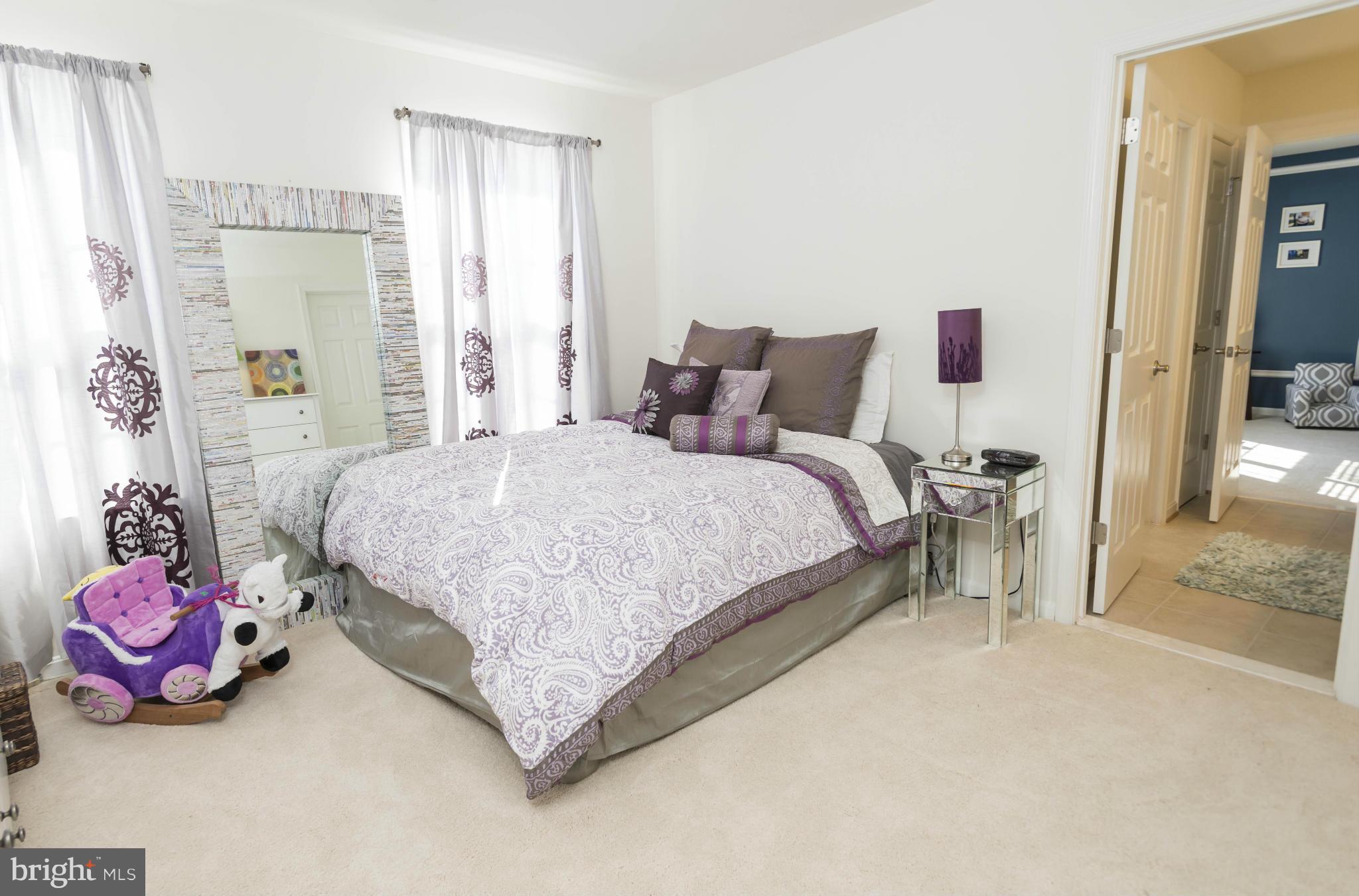 2302 Winterwood Road Baltimore, MD 21209 - Photo 27 of 30 a bedroom with a bed and a chandelier