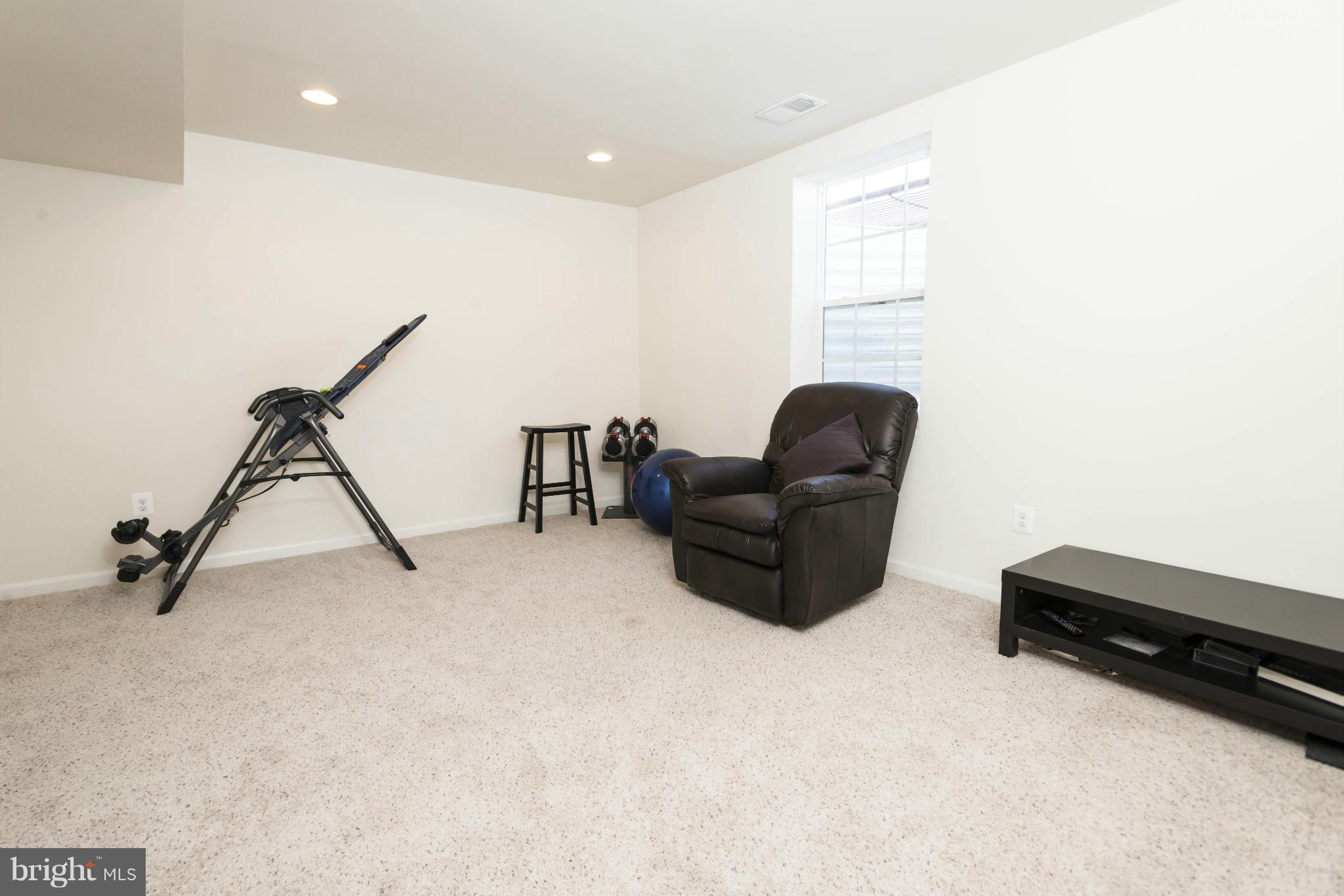 2302 Winterwood Road Baltimore, MD 21209 - Photo 28 of 30 a living room with furniture and a flat screen tv