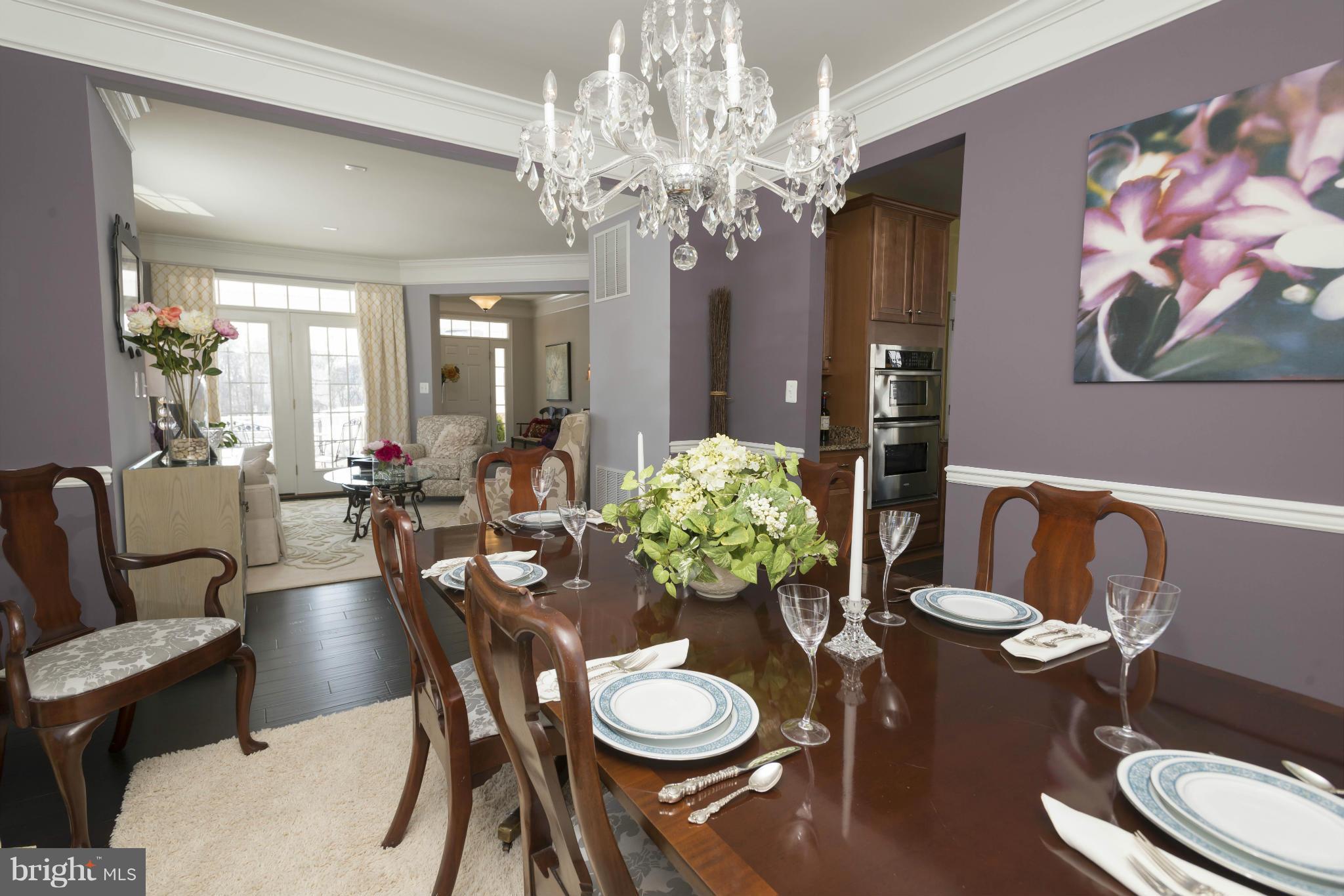 2302 Winterwood Road Baltimore, MD 21209 - Photo 5 of 30 a dining room with furniture a chandelier and wooden floor
