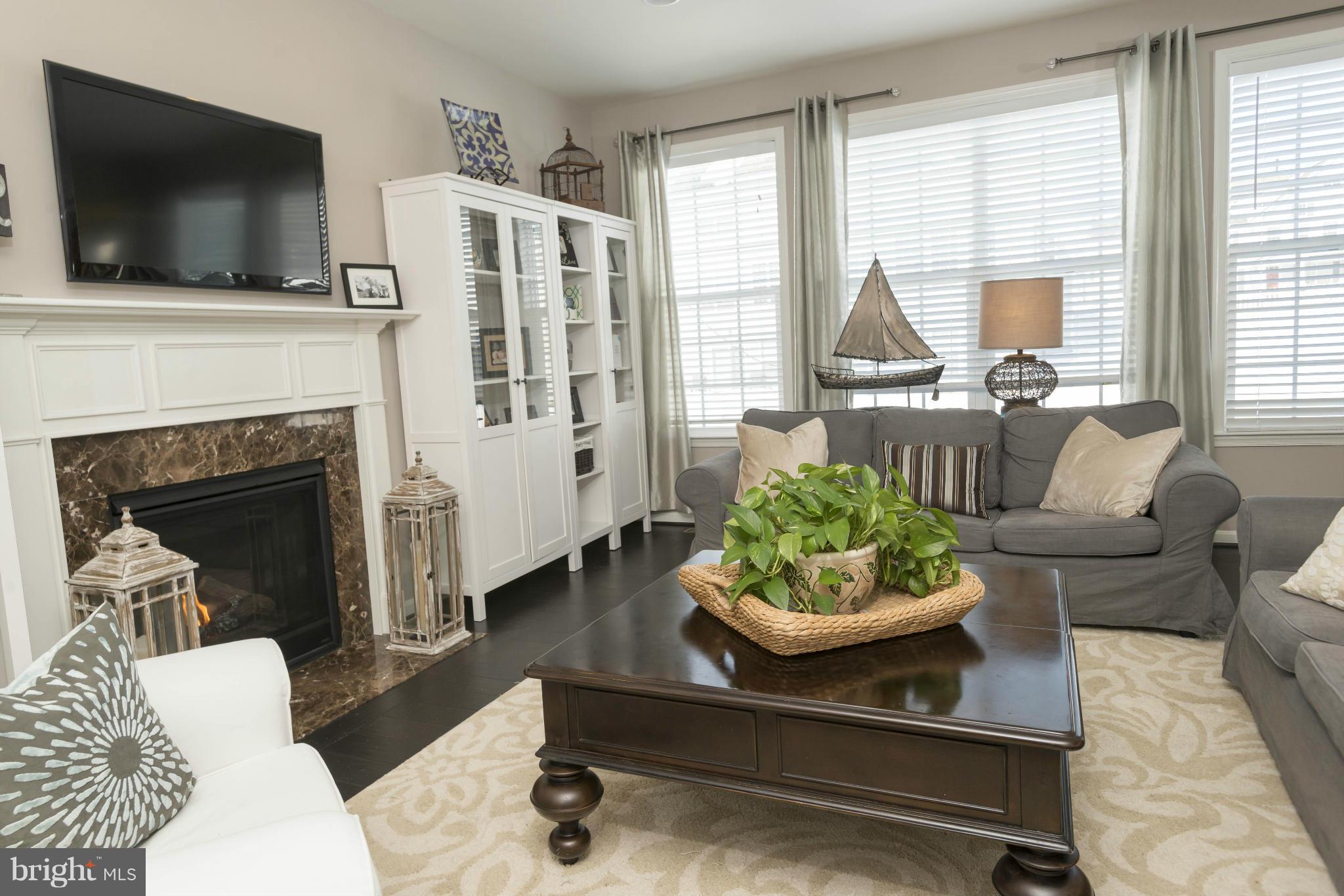 2302 Winterwood Road Baltimore, MD 21209 - Photo 10 of 30 a living room with furniture and a fireplace