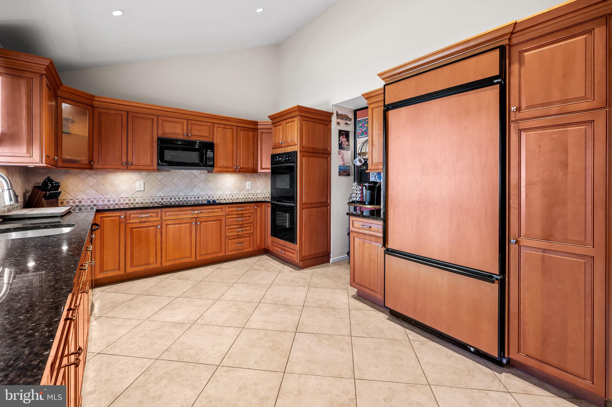 8014 Melody Lane, Unit 8014 Baltimore, MD 21208 - Photo 14 of 51 a kitchen with stainless steel appliances granite countertop a refrigerator and a sink