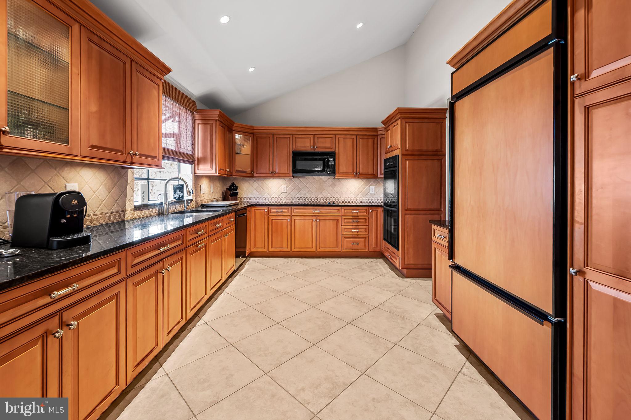 8014 Melody Lane, Unit 8014 Baltimore, MD 21208 - Photo 15 of 51 a large kitchen with stainless steel appliances granite countertop a refrigerator and a sink