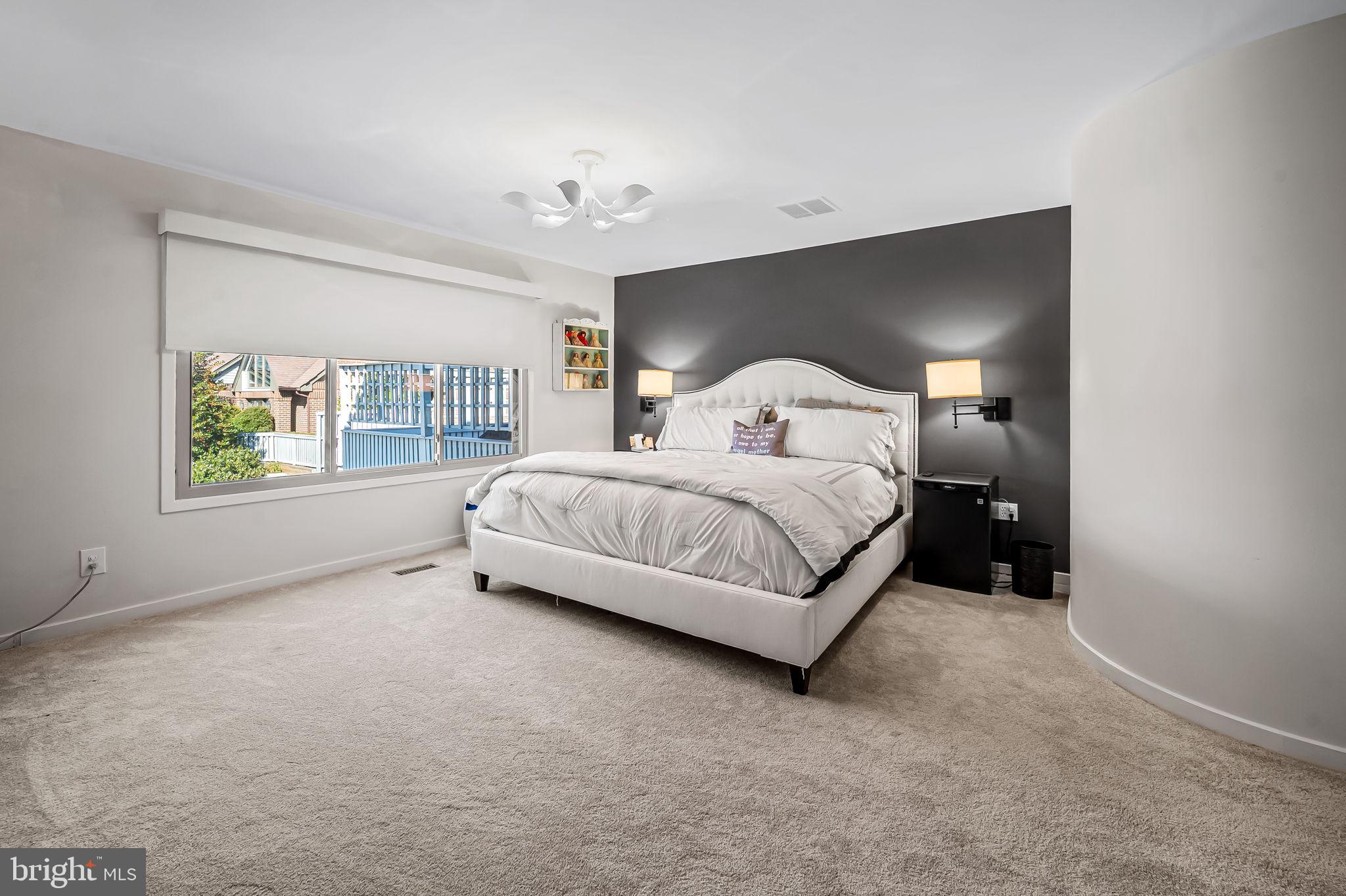 8014 Melody Lane, Unit 8014 Baltimore, MD 21208 - Photo 19 of 51 a living room with a bed furniture and a window