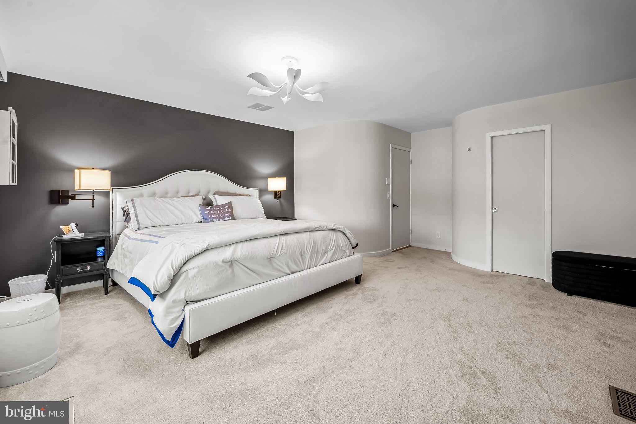 8014 Melody Lane, Unit 8014 Baltimore, MD 21208 - Photo 20 of 51 a bedroom with a bed and a lamp