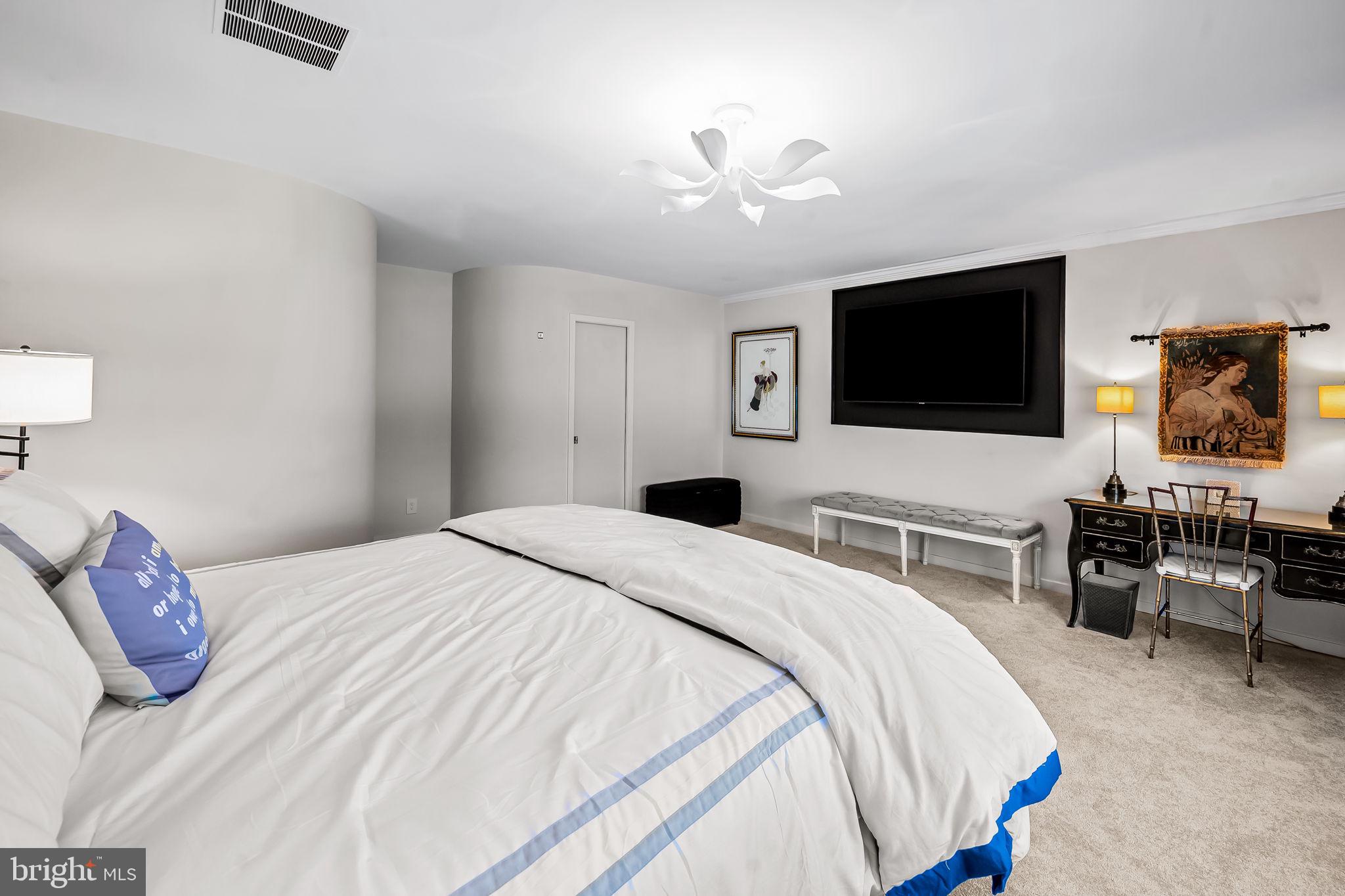 8014 Melody Lane, Unit 8014 Baltimore, MD 21208 - Photo 21 of 51 a bedroom with a bed and a flat screen tv