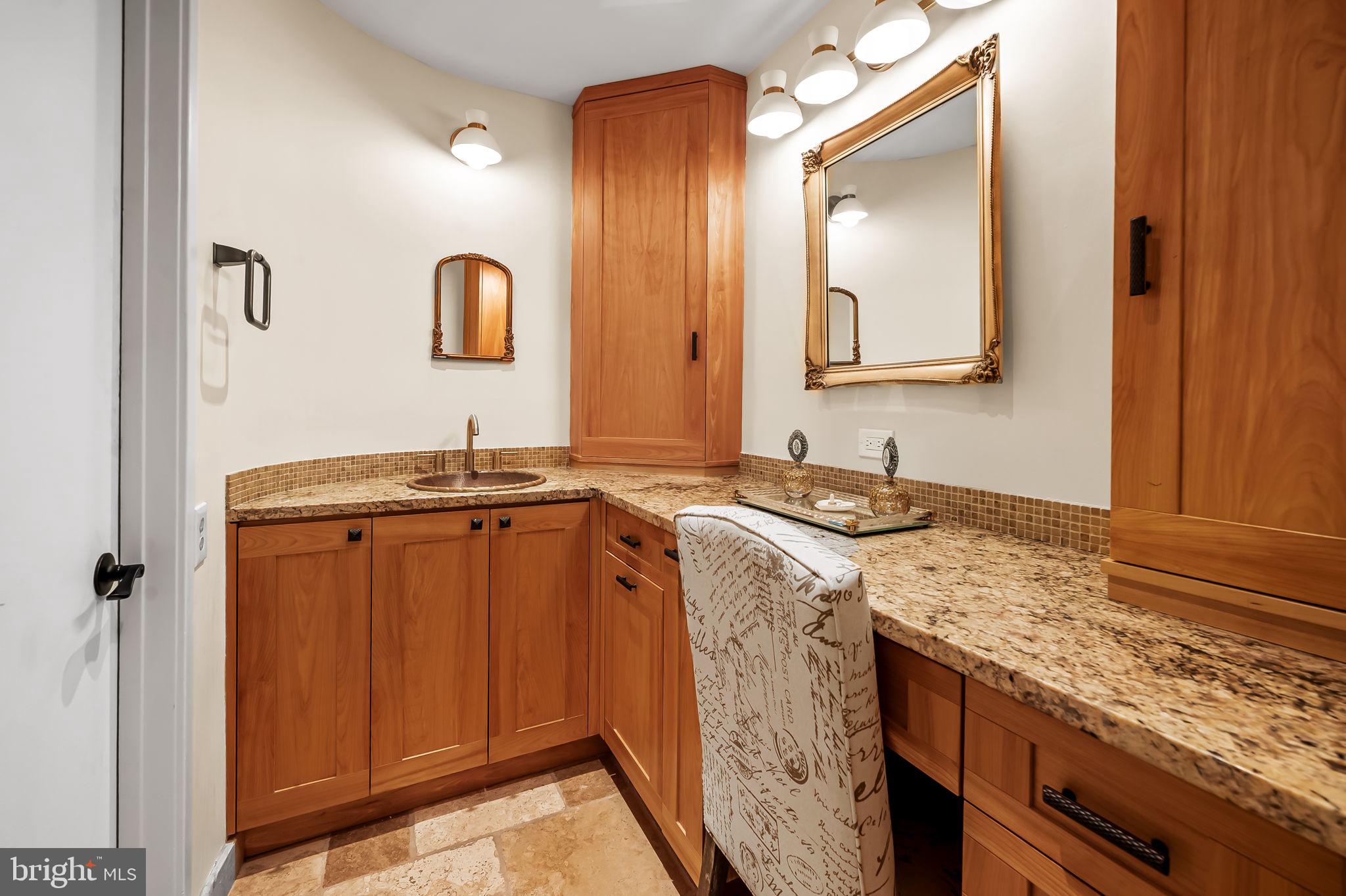 8014 Melody Lane, Unit 8014 Baltimore, MD 21208 - Photo 22 of 51 a bathroom with a granite countertop sink and a mirror