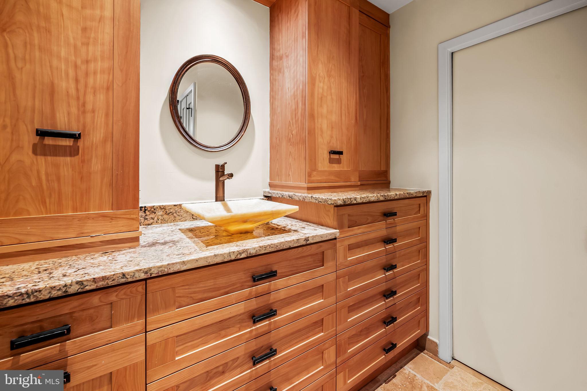 8014 Melody Lane, Unit 8014 Baltimore, MD 21208 - Photo 23 of 51 a bathroom with a granite countertop sink and a mirror