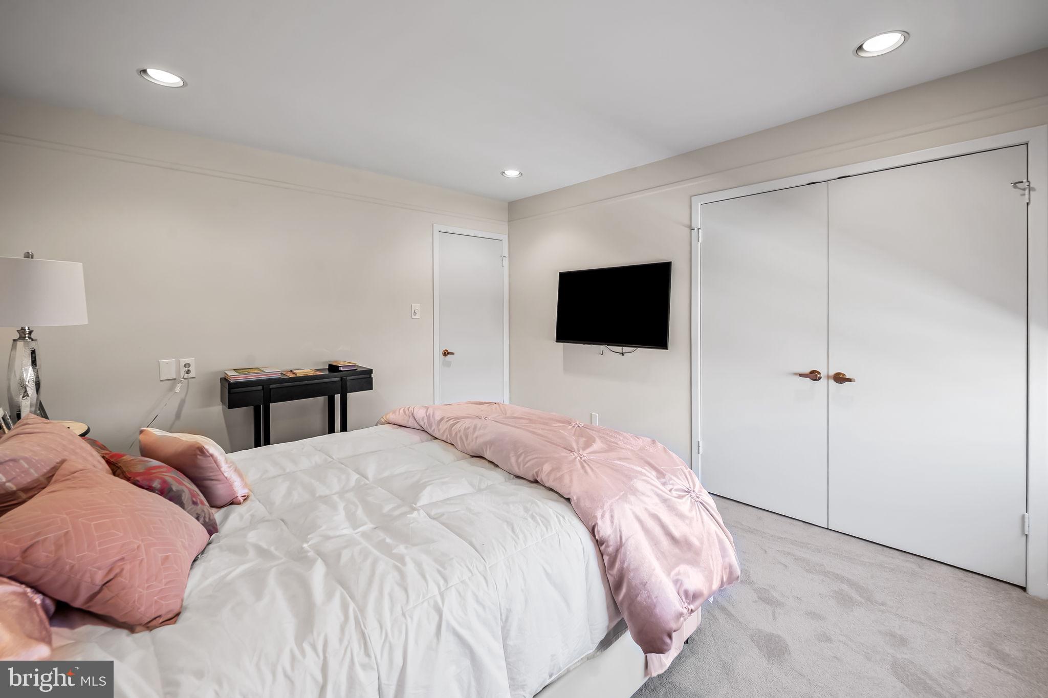 8014 Melody Lane, Unit 8014 Baltimore, MD 21208 - Photo 29 of 51 a bedroom with a bed and a flat screen tv