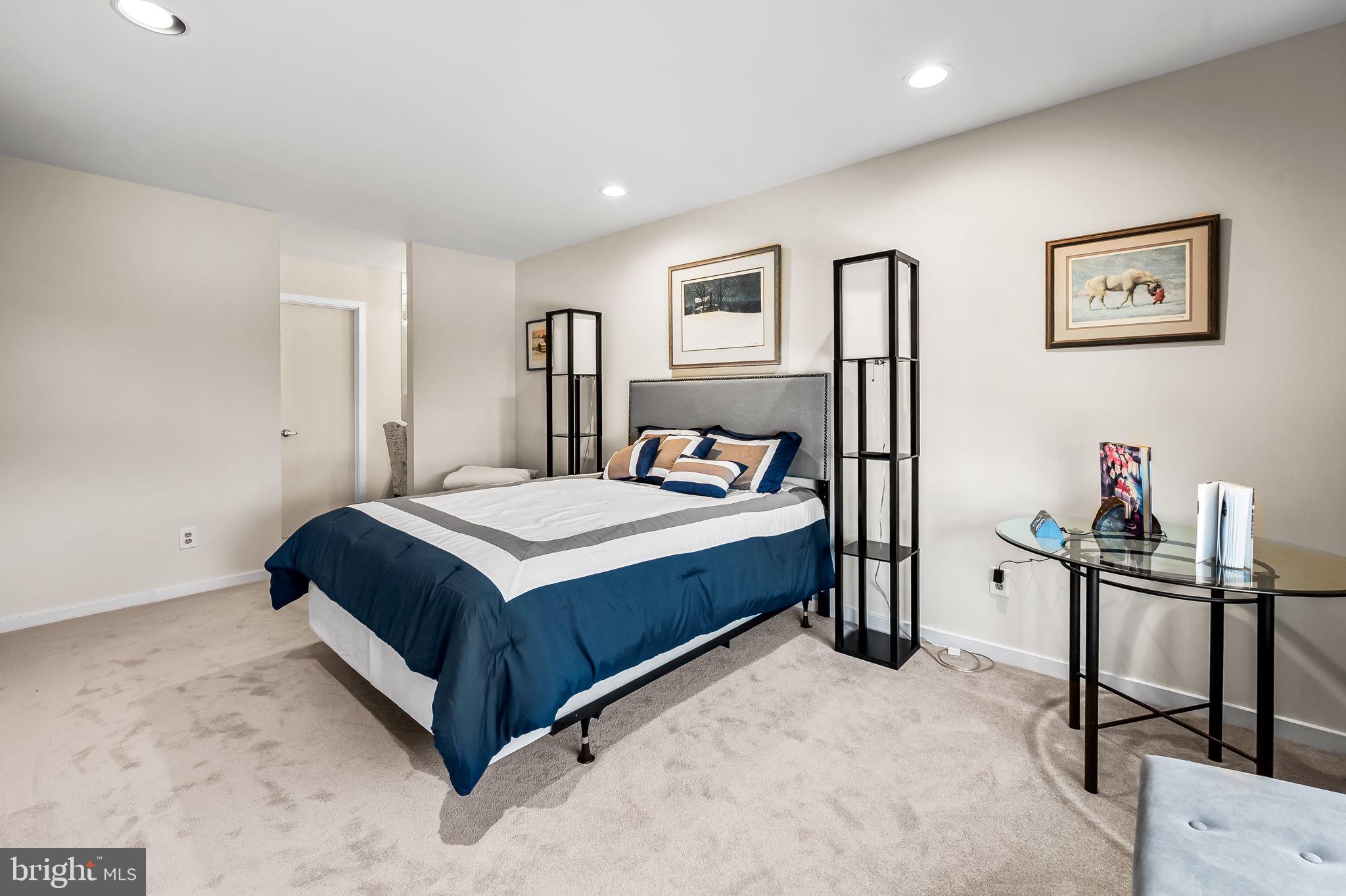 8014 Melody Lane, Unit 8014 Baltimore, MD 21208 - Photo 31 of 51 a bedroom with a bed and a desk in it