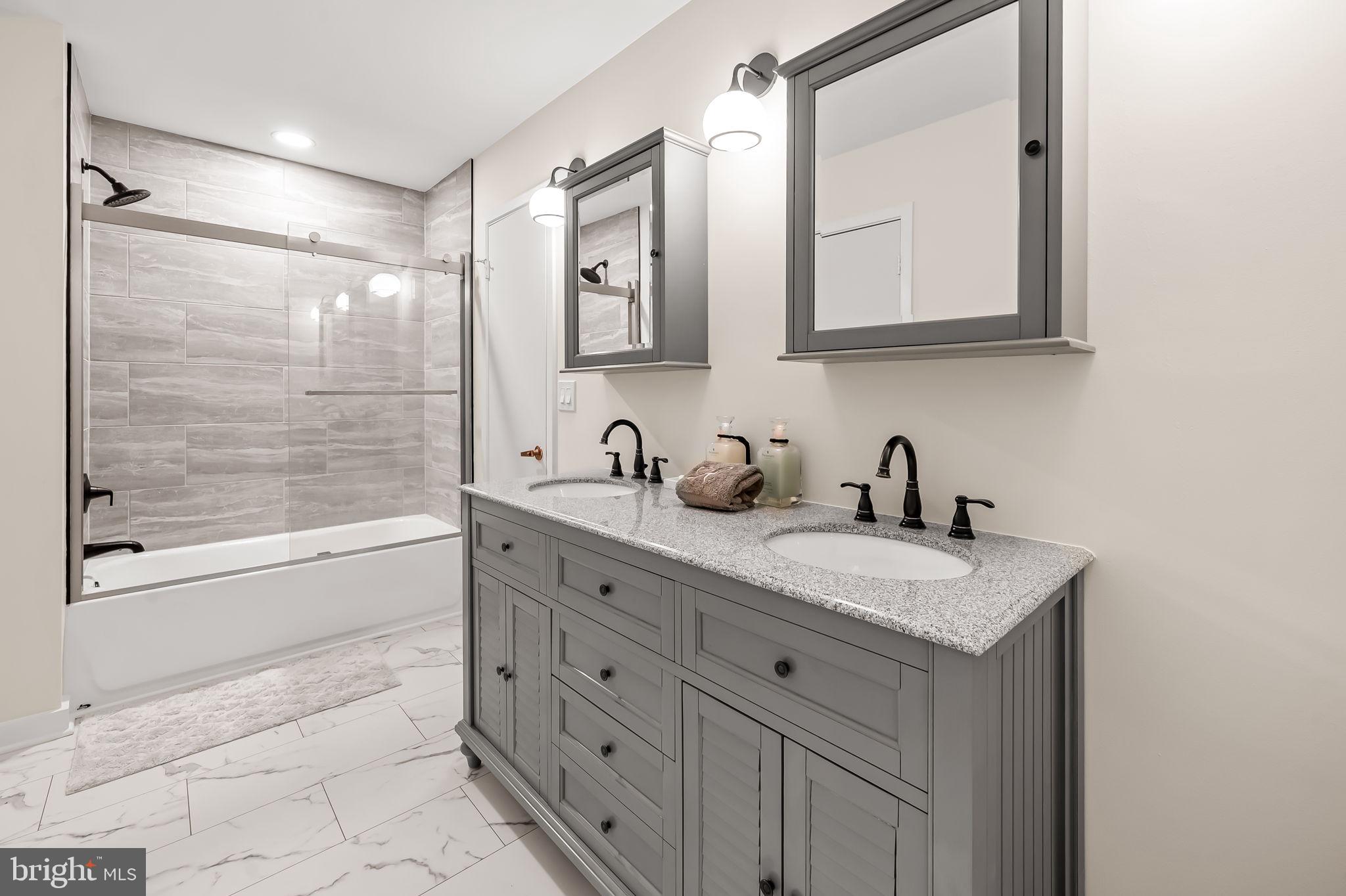 8014 Melody Lane, Unit 8014 Baltimore, MD 21208 - Photo 32 of 51 a bathroom with a granite countertop sink mirror and