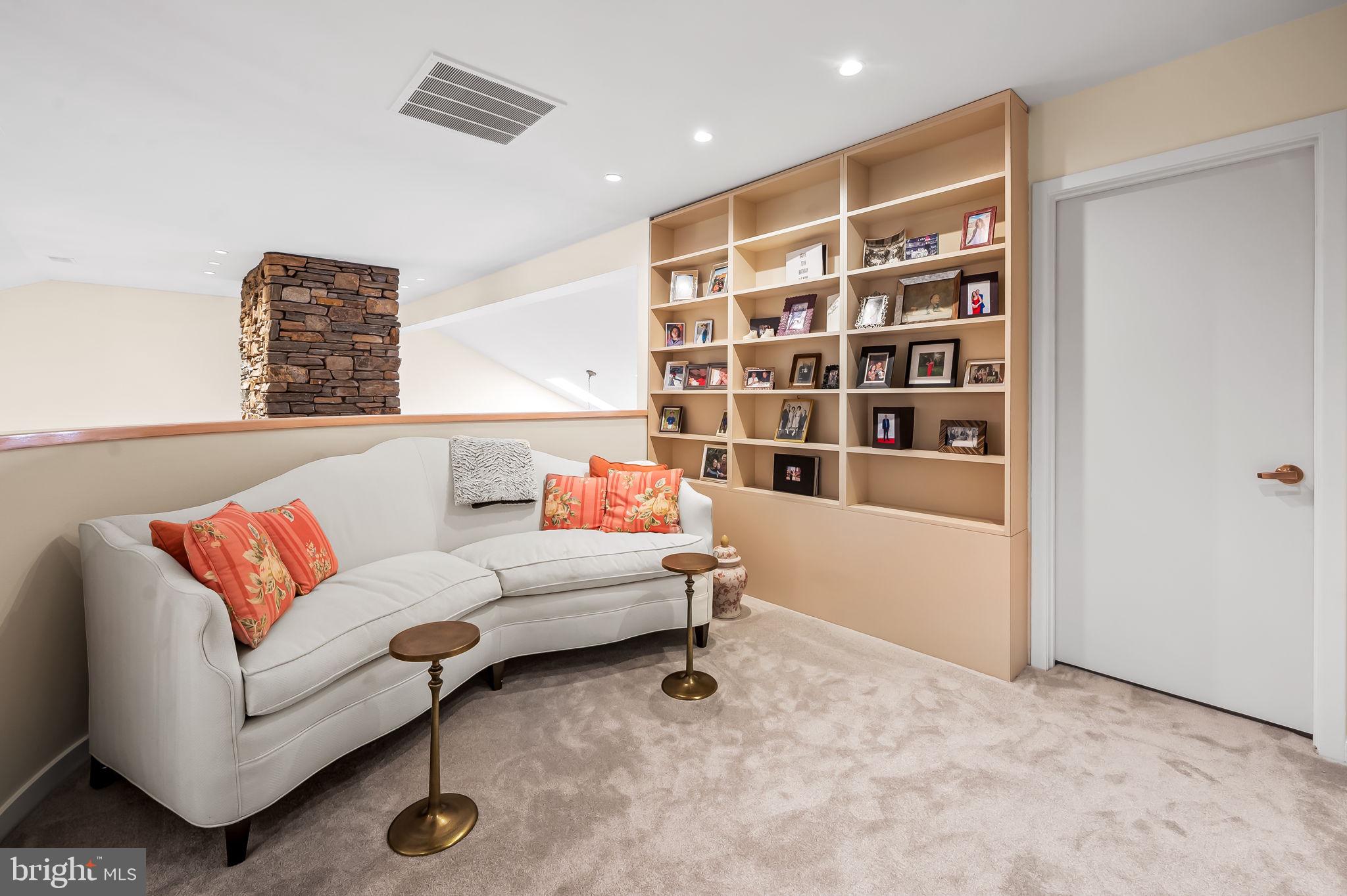 8014 Melody Lane, Unit 8014 Baltimore, MD 21208 - Photo 34 of 51 a living room with furniture and a book shelf