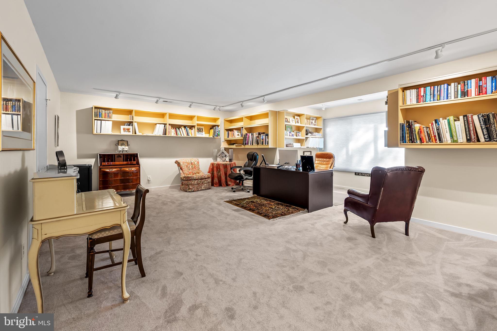 8014 Melody Lane, Unit 8014 Baltimore, MD 21208 - Photo 35 of 51 a living room with furniture and a book shelf