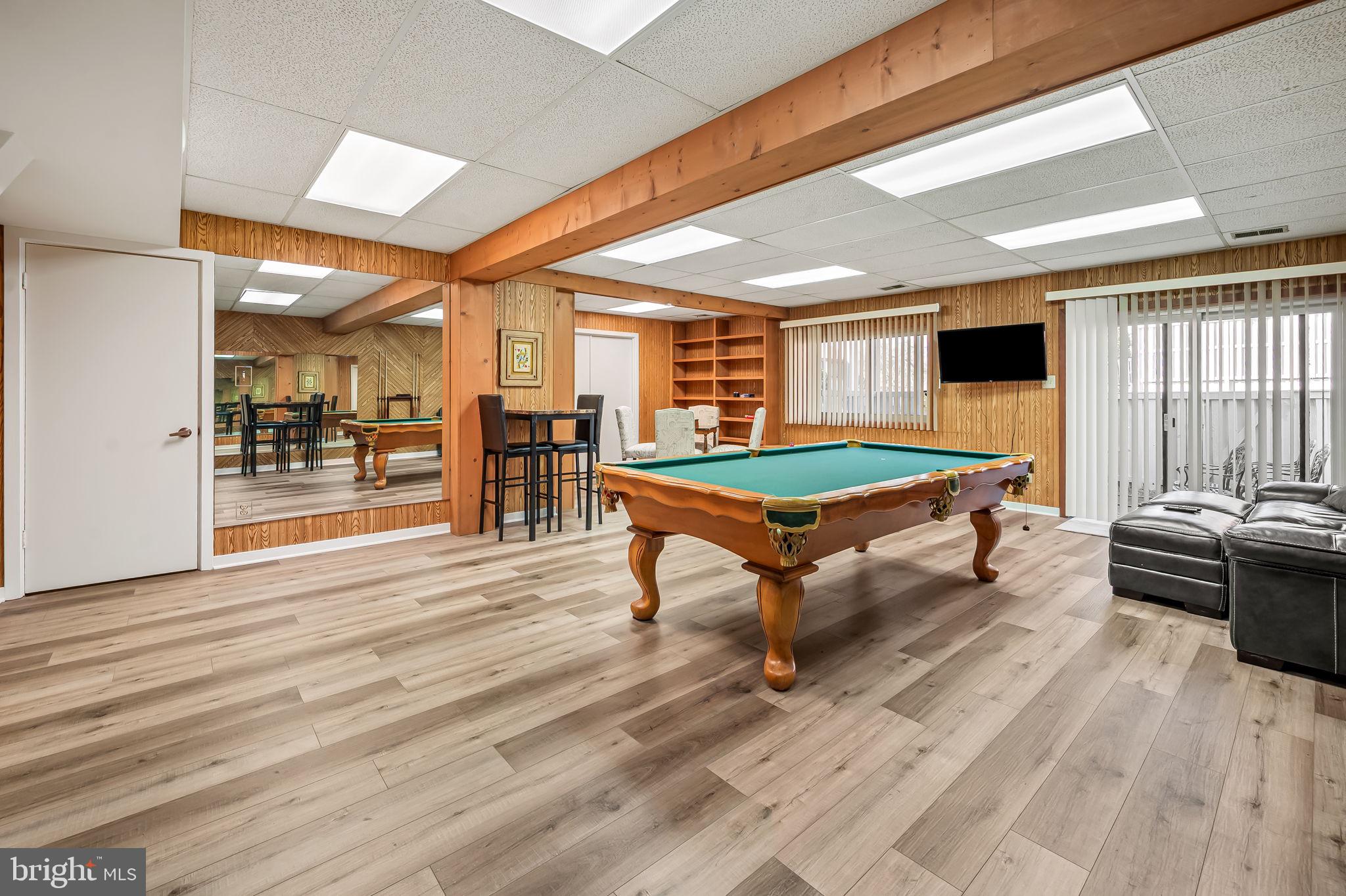 8014 Melody Lane, Unit 8014 Baltimore, MD 21208 - Photo 38 of 51 a room with pool table and wooden floor