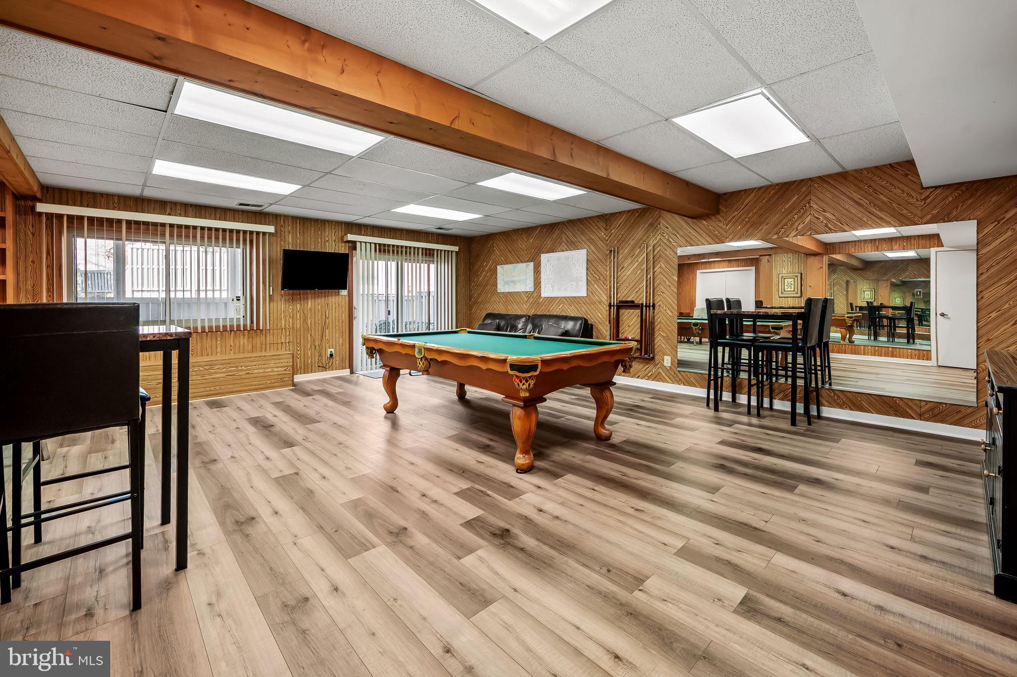 8014 Melody Lane, Unit 8014 Baltimore, MD 21208 - Photo 39 of 51 a living room with furniture a wooden floor and next to a window