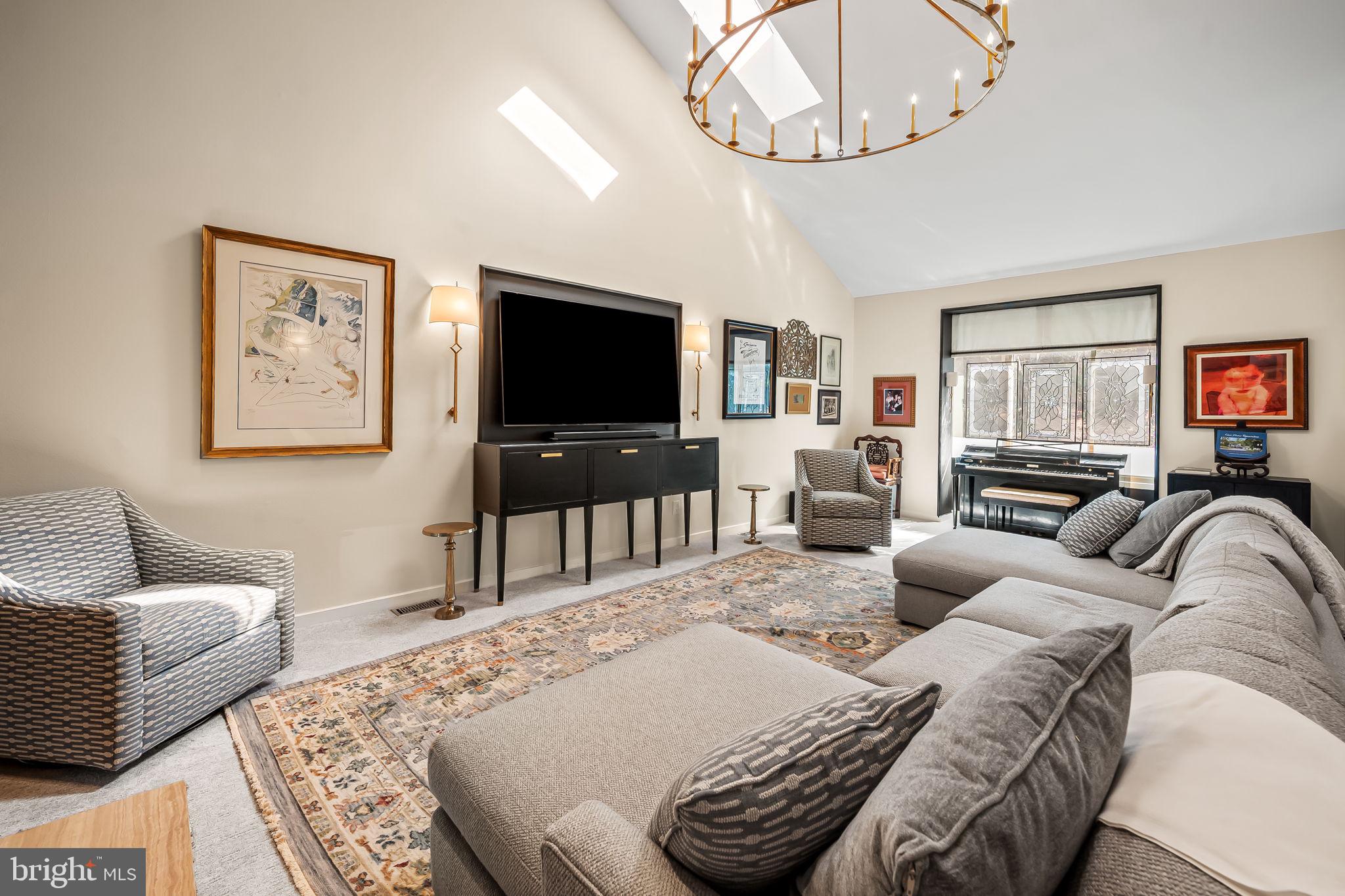 8014 Melody Lane, Unit 8014 Baltimore, MD 21208 - Photo 5 of 51 a living room with furniture a large window and a flat screen tv