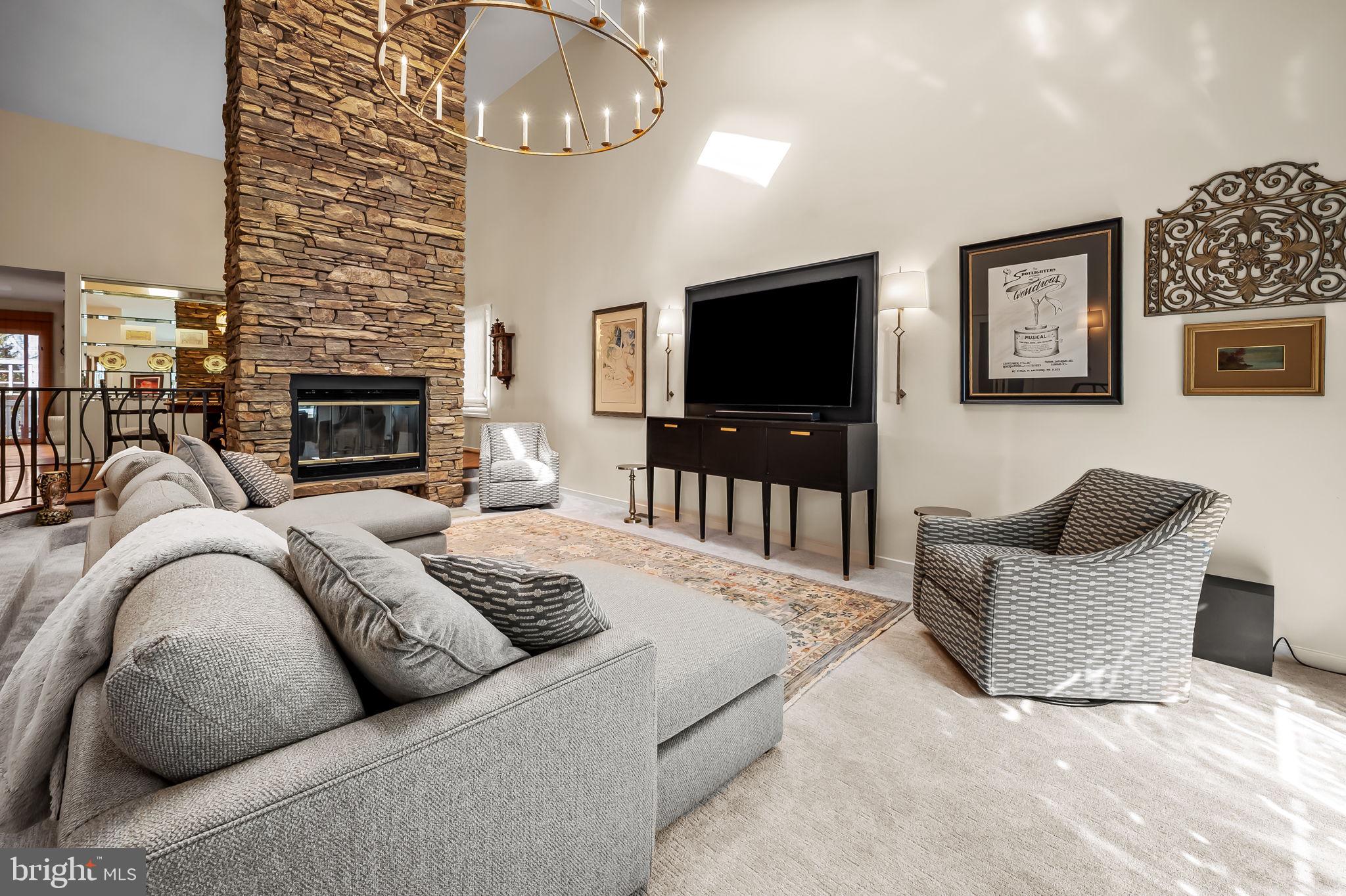 8014 Melody Lane, Unit 8014 Baltimore, MD 21208 - Photo 6 of 51 a living room with furniture a fireplace and a flat screen tv