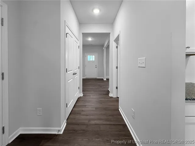 a view of a hallway with wooden floor