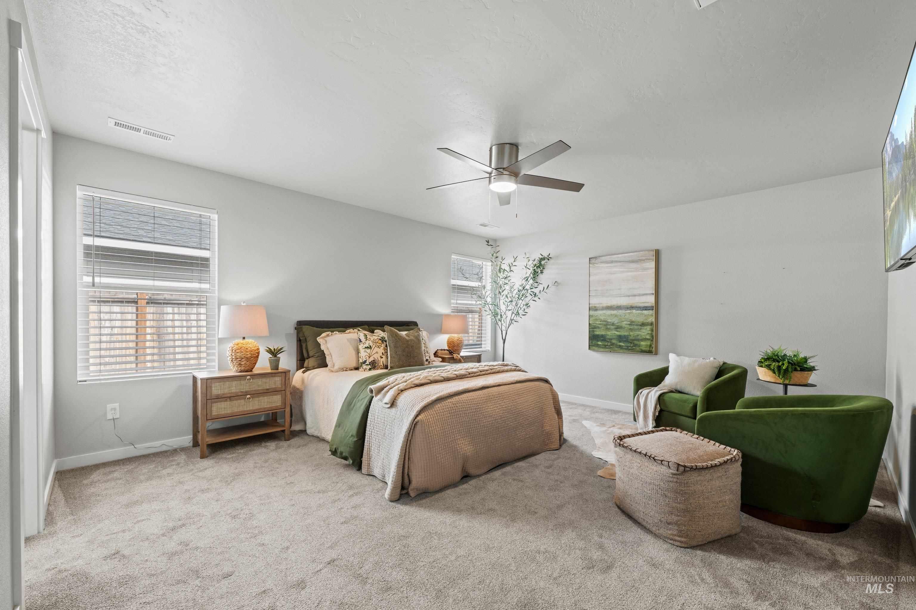 12744 West Fig Street Boise, ID 83713 - Photo 25 of 34 Carpeted bedroom featuring a ceiling fan with integrated lighting, two windows with blinds, and light gray wall paint