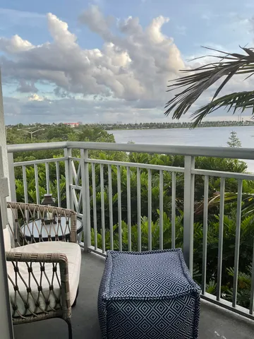 a balcony with table and chairs