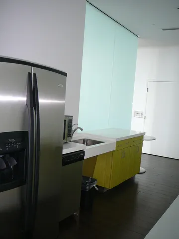 a room with lots of gym equipment and a view of living room