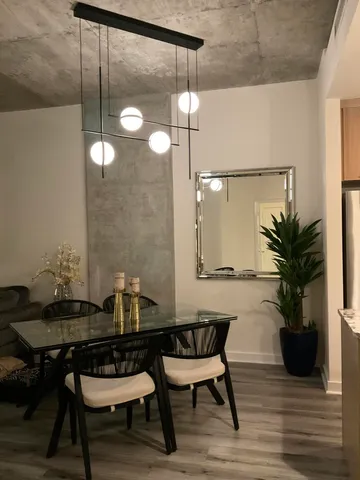 a dining room with furniture and wooden floor