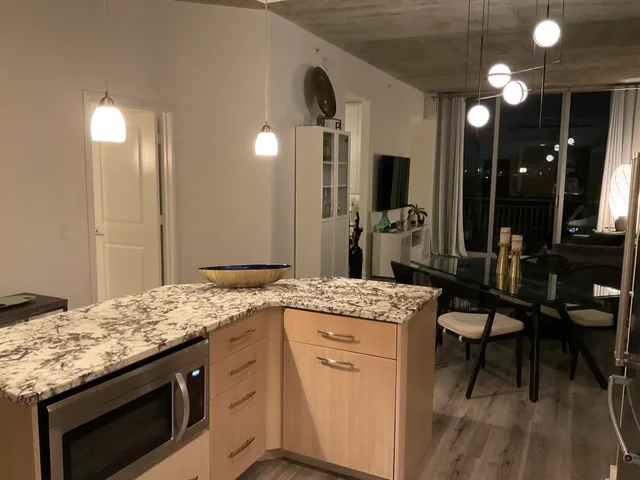 a kitchen with a stove and a wooden floor