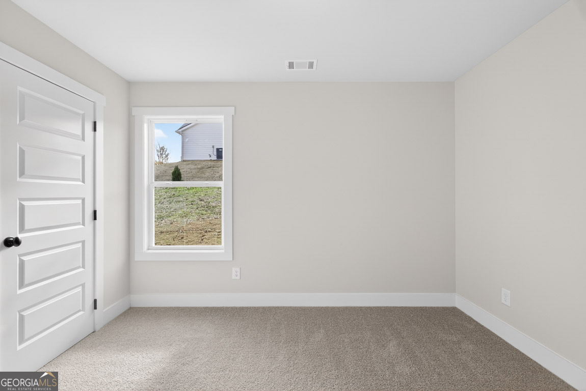 230 Airport Road, Unit 9 Canon, GA 30520 - Photo 26 of 36 an empty room with windows and closet