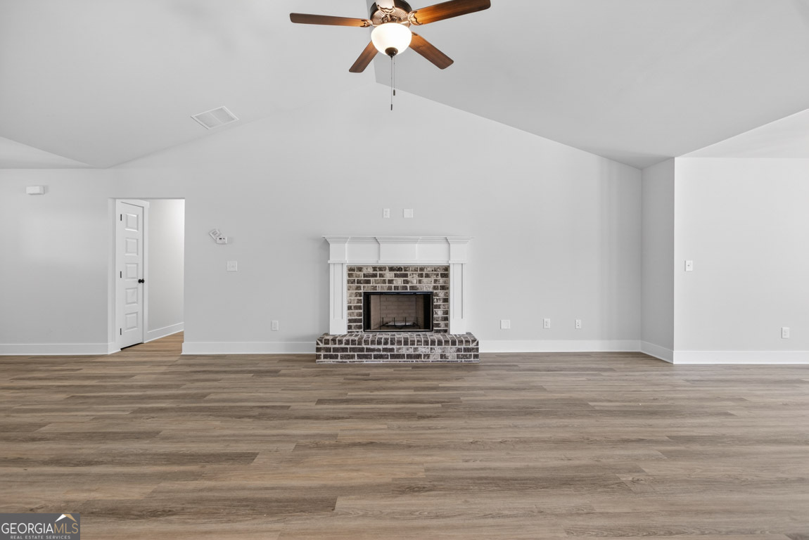 230 Airport Road, Unit 9 Canon, GA 30520 - Photo 4 of 36 a view of an empty room with a fireplace and a window
